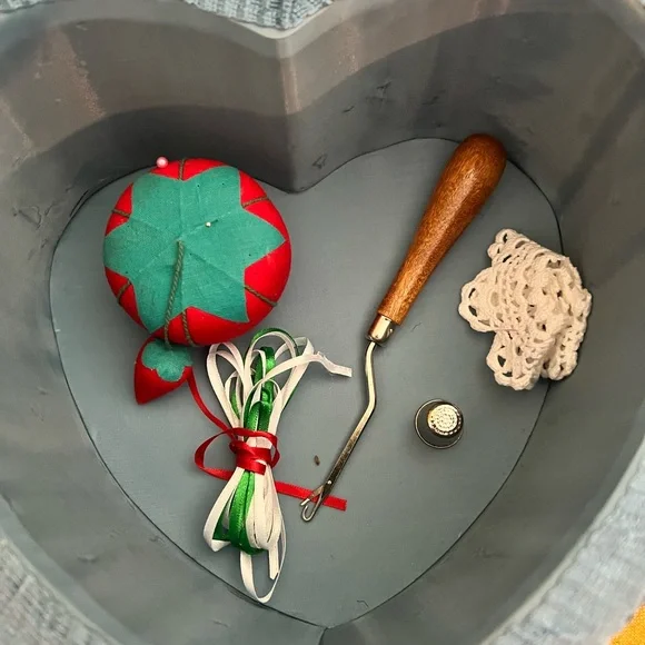 Vintage like new floral heart shaped sewing box. Comes with some sewing tools.